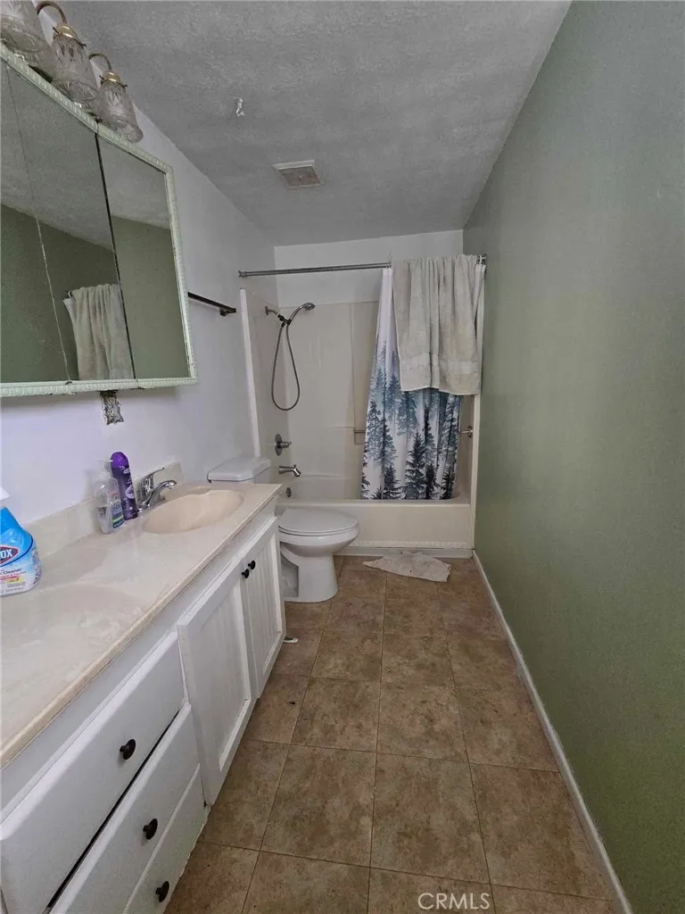 36614 Leona Road Barstow, CA 92311 - Photo 18 of 24 a bathroom with a granite countertop sink a toilet and shower