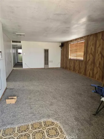 a room with window and refrigerator