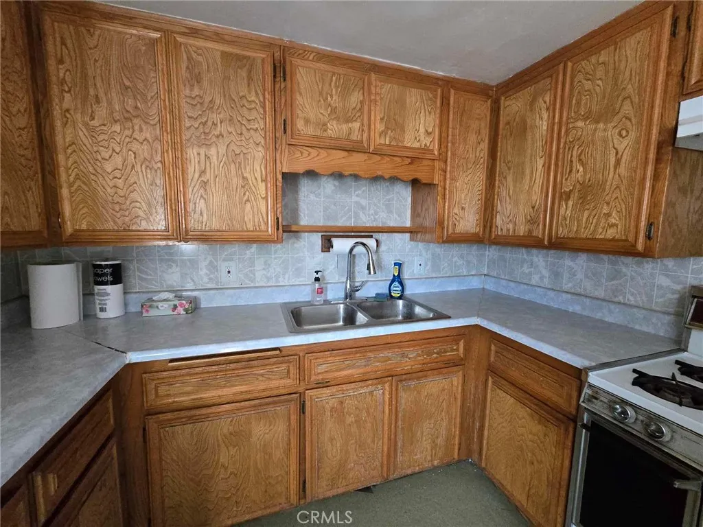 36614 Leona Road Barstow, CA 92311 - Photo 8 of 24 a kitchen with a sink cabinets and window