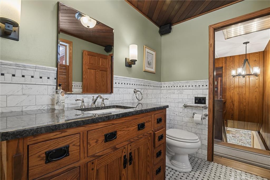 121 Brewer Road Saxonburg, PA 16056 - Photo 24 of 49 a bathroom with a granite countertop toilet sink and mirror