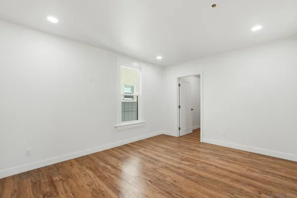 wooden floor in an empty room with a window