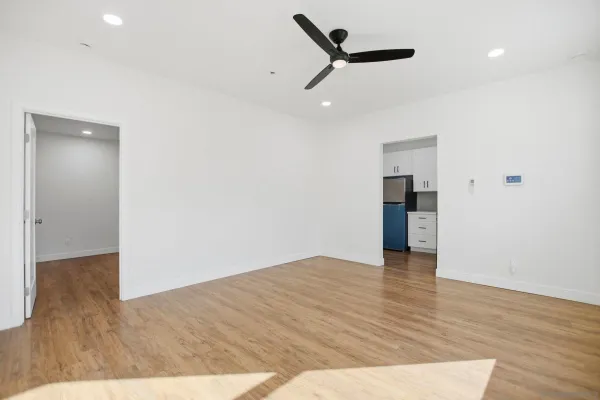 a view of an empty room with wooden floor