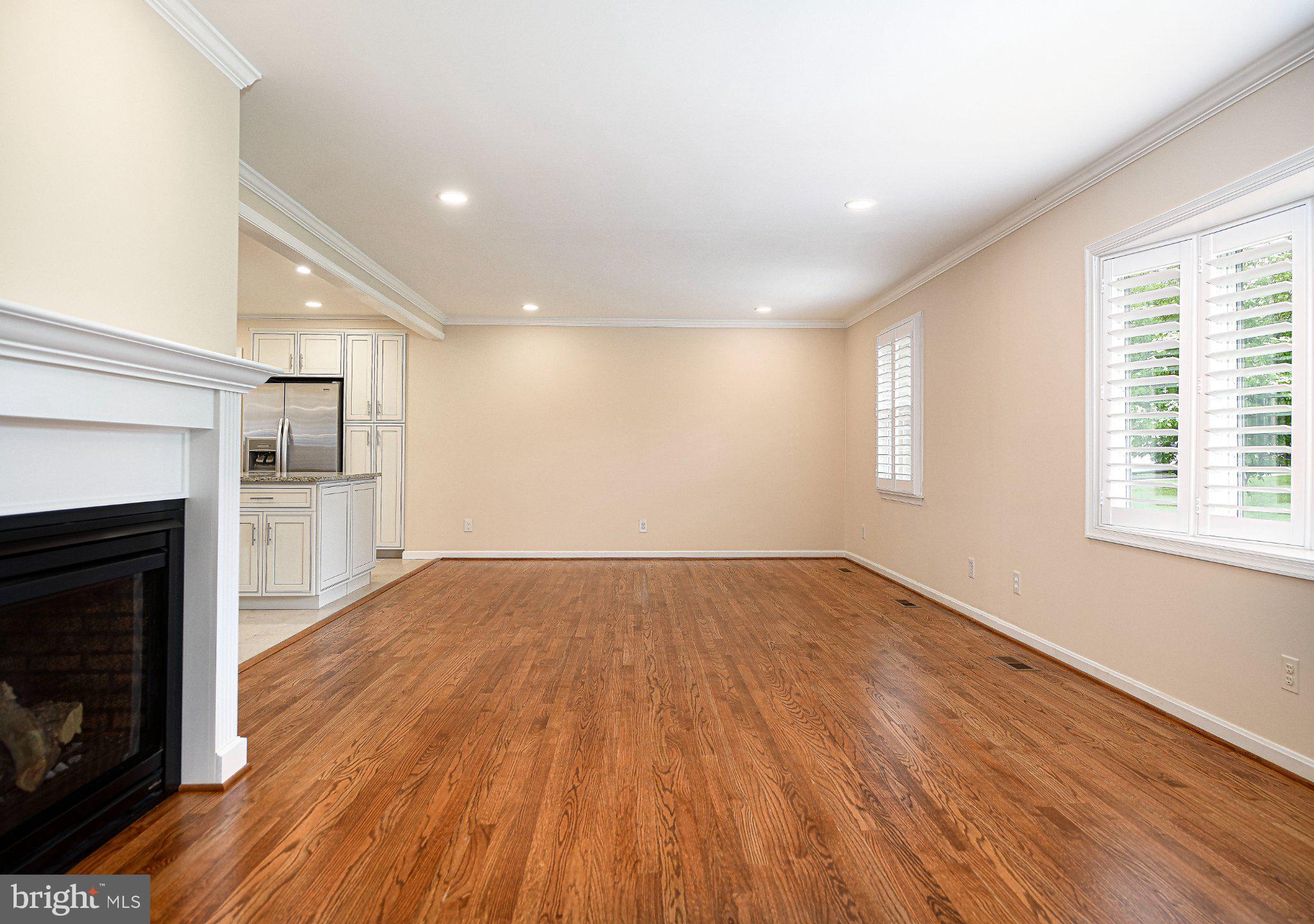 14300 Carroll Ridge Court Baldwin, MD 21013 - Photo 11 of 73 a view of an empty room with wooden floor fireplace and a window