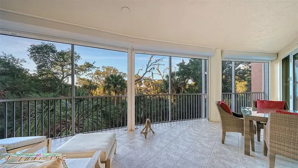 a living room with furniture and a floor to ceiling window