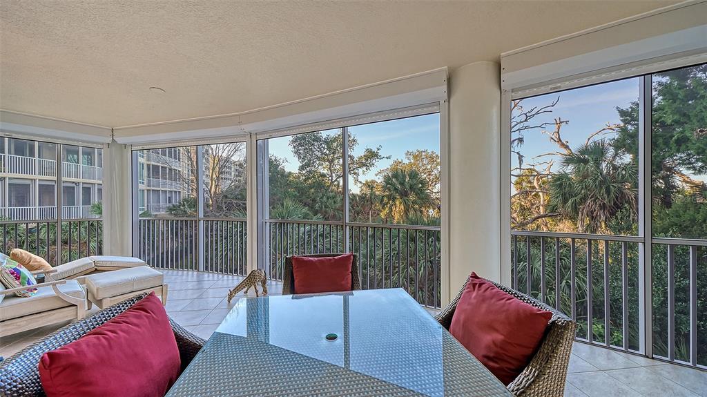 3621 North Point Road, Unit 301 Osprey, FL 34229 - Photo 16 of 95 a living room with furniture and a floor to ceiling window