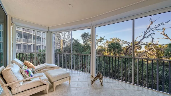 a view of a dining room and livingroom with furniture wooden floor a chandelier