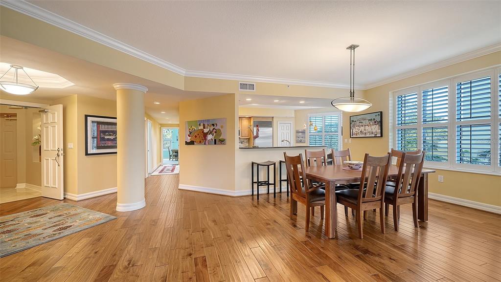 3621 North Point Road, Unit 301 Osprey, FL 34229 - Photo 22 of 95 a view of a dining room and livingroom with furniture wooden floor a chandelier