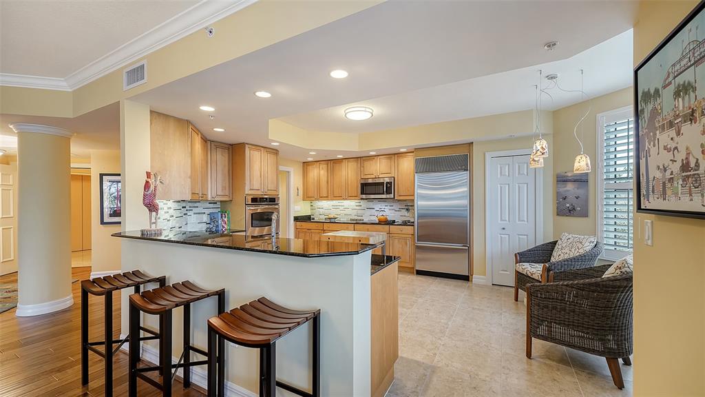 3621 North Point Road, Unit 301 Osprey, FL 34229 - Photo 24 of 95 a kitchen with stainless steel appliances kitchen island granite countertop a sink and cabinets