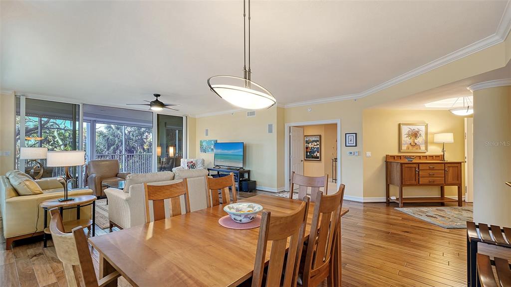 3621 North Point Road, Unit 301 Osprey, FL 34229 - Photo 25 of 95 a view of a dining room with furniture window and wooden floor