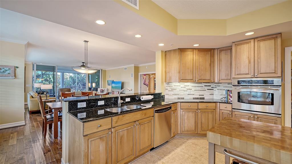 3621 North Point Road, Unit 301 Osprey, FL 34229 - Photo 27 of 95 a kitchen with stainless steel appliances granite countertop a sink and cabinets