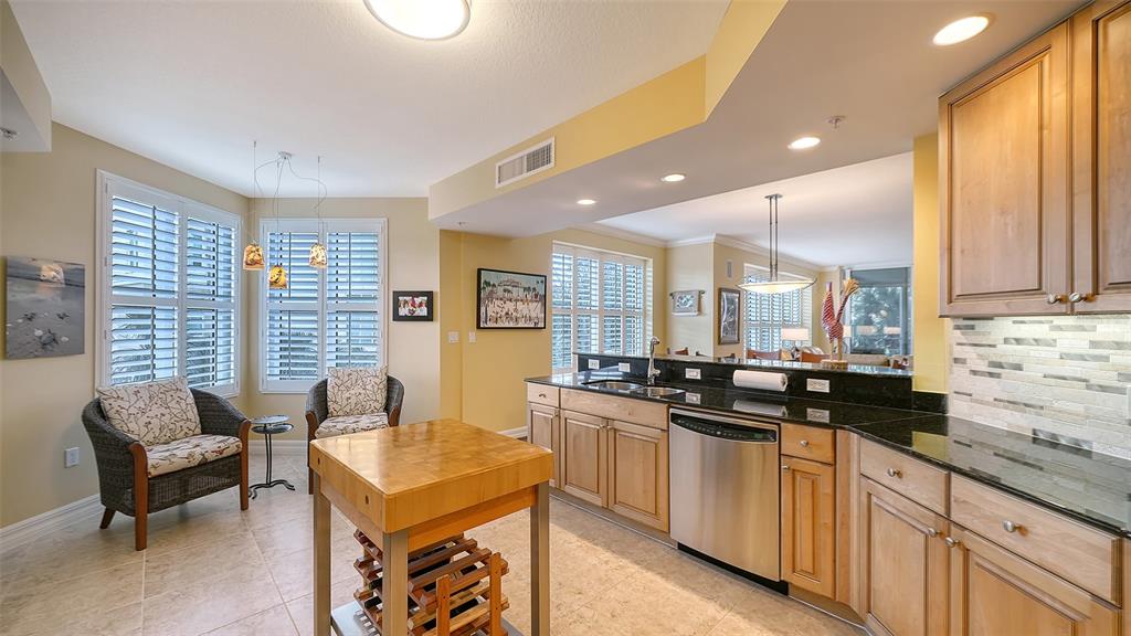 3621 North Point Road, Unit 301 Osprey, FL 34229 - Photo 28 of 95 a kitchen with a sink stove and cabinets