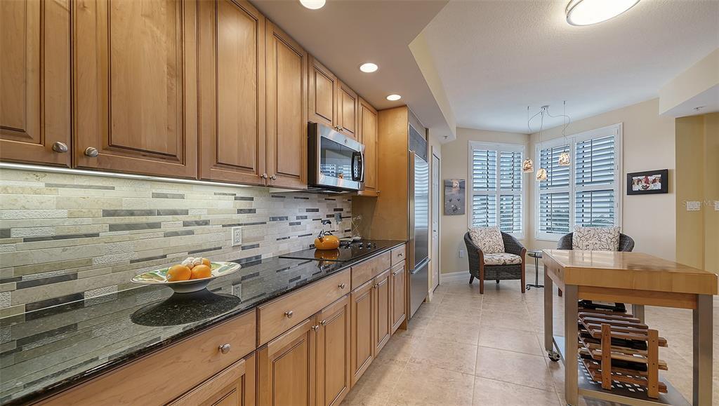 3621 North Point Road, Unit 301 Osprey, FL 34229 - Photo 29 of 95 a kitchen with stainless steel appliances granite countertop a stove a sink and a microwave