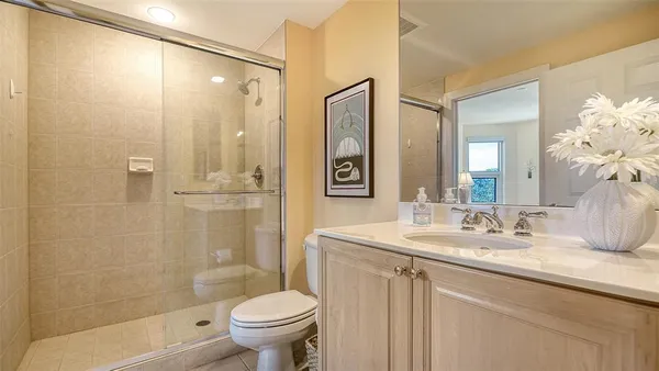 a front view of a house with a yard and palm trees