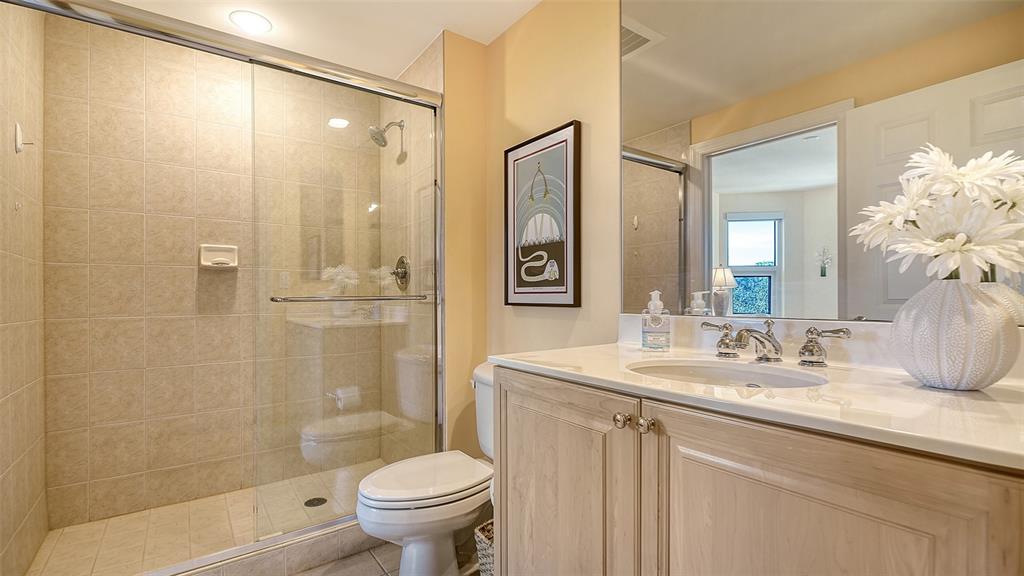 3621 North Point Road, Unit 301 Osprey, FL 34229 - Photo 41 of 95 a bathroom with a sink a toilet and shower