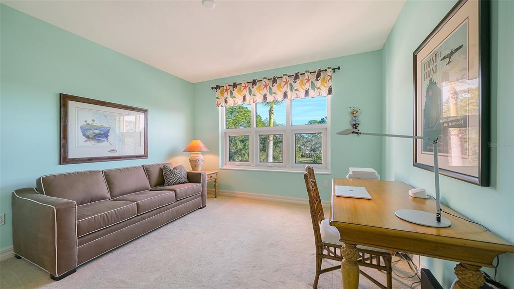 3621 North Point Road, Unit 301 Osprey, FL 34229 - Photo 42 of 95 a living room with furniture and a window