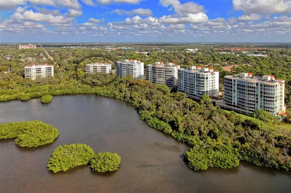 an aerial view of a house with outdoor space and lake view
