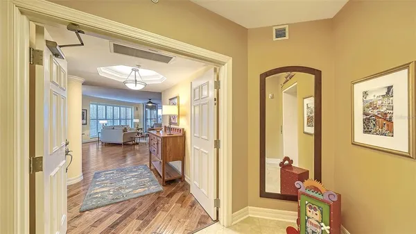 a living room with furniture tv and wooden floor