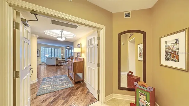 a living room with furniture tv and wooden floor