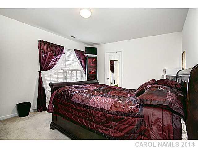 9223 Yellow Oak Road Charlotte, NC 28227 - Photo 15 of 15 a bedroom with a bed and a painting on the wall