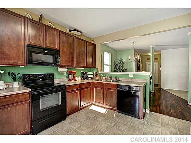 9223 Yellow Oak Road Charlotte, NC 28227 - Photo 4 of 15 a kitchen with stainless steel appliances granite countertop a stove a sink and a microwave