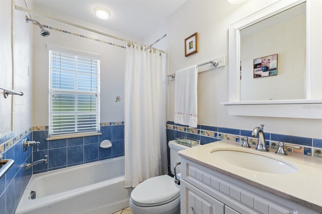 5856 Gasparilla Road, Unit MV28 Boca Grande, FL 33921 - Photo 13 of 21 a bathroom with a granite countertop sink toilet and shower
