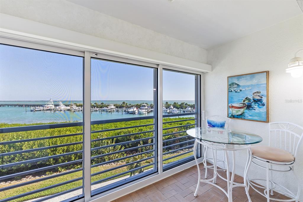 5856 Gasparilla Road, Unit MV28 Boca Grande, FL 33921 - Photo 15 of 21 a dining room with furniture and a floor to ceiling window