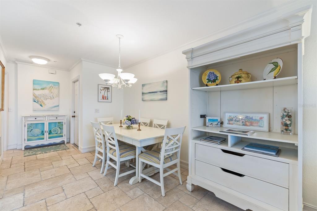 5856 Gasparilla Road, Unit MV28 Boca Grande, FL 33921 - Photo 7 of 21 a view of a dining room with furniture and chandelier