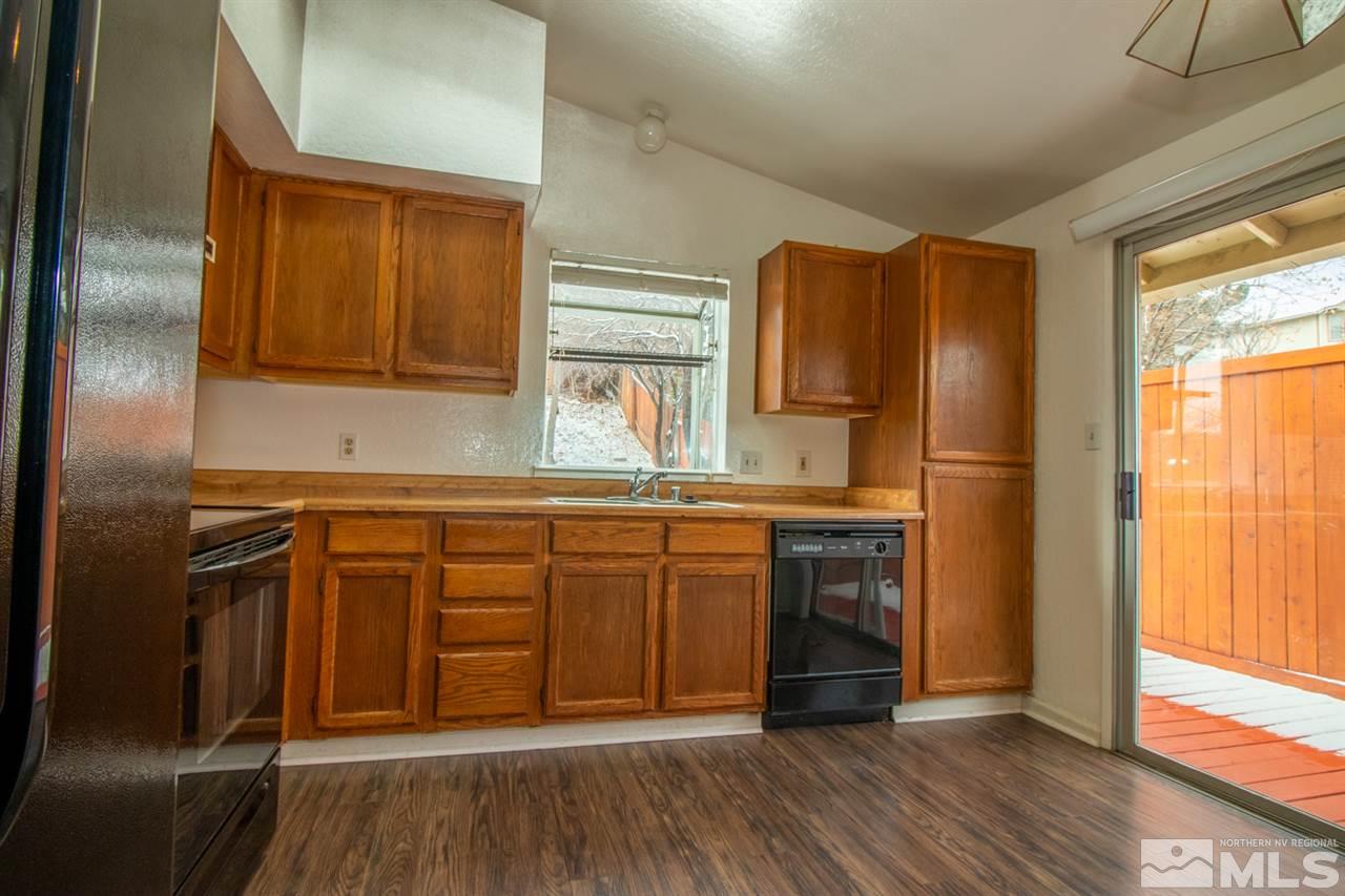 6480 Enchanted Valley Drive Reno, NV 89523 - Photo 2 of 12 a kitchen with stainless steel appliances granite countertop a refrigerator and a sink