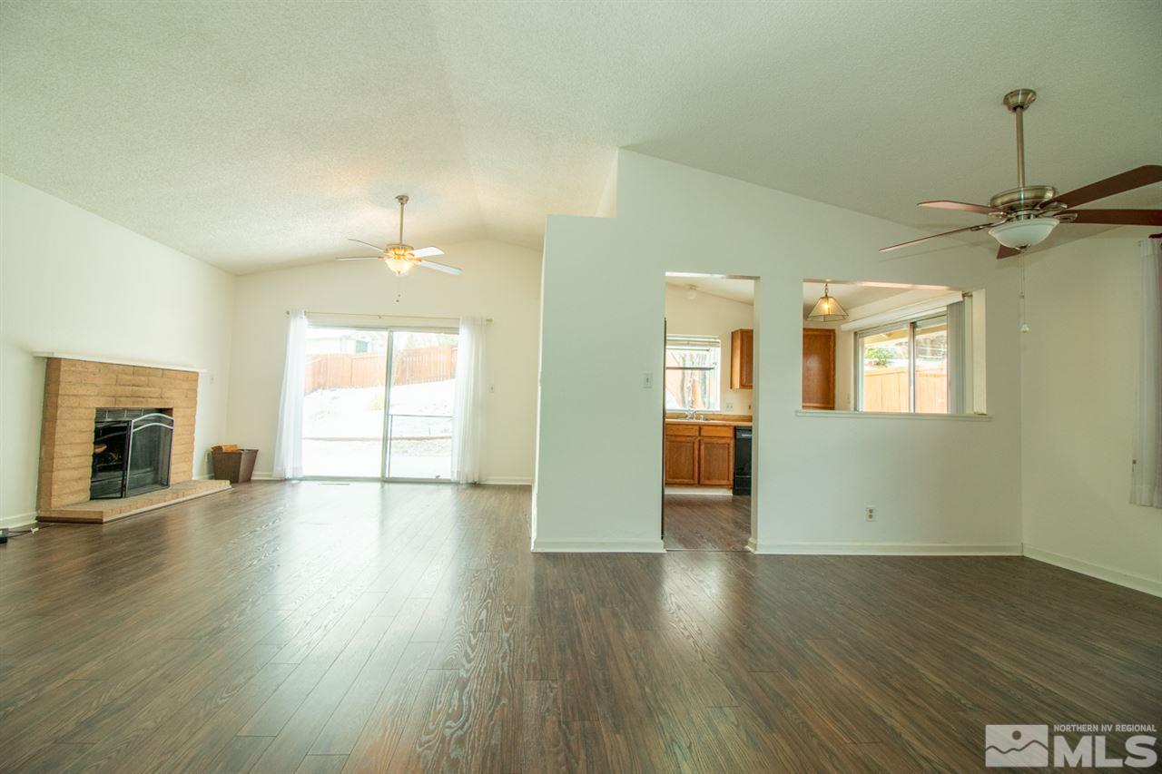 6480 Enchanted Valley Drive Reno, NV 89523 - Photo 4 of 12 an empty room with wooden floor and windows