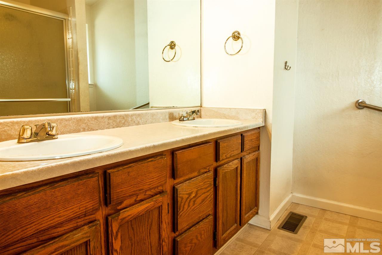 6480 Enchanted Valley Drive Reno, NV 89523 - Photo 7 of 12 a bathroom with a sink and a mirror