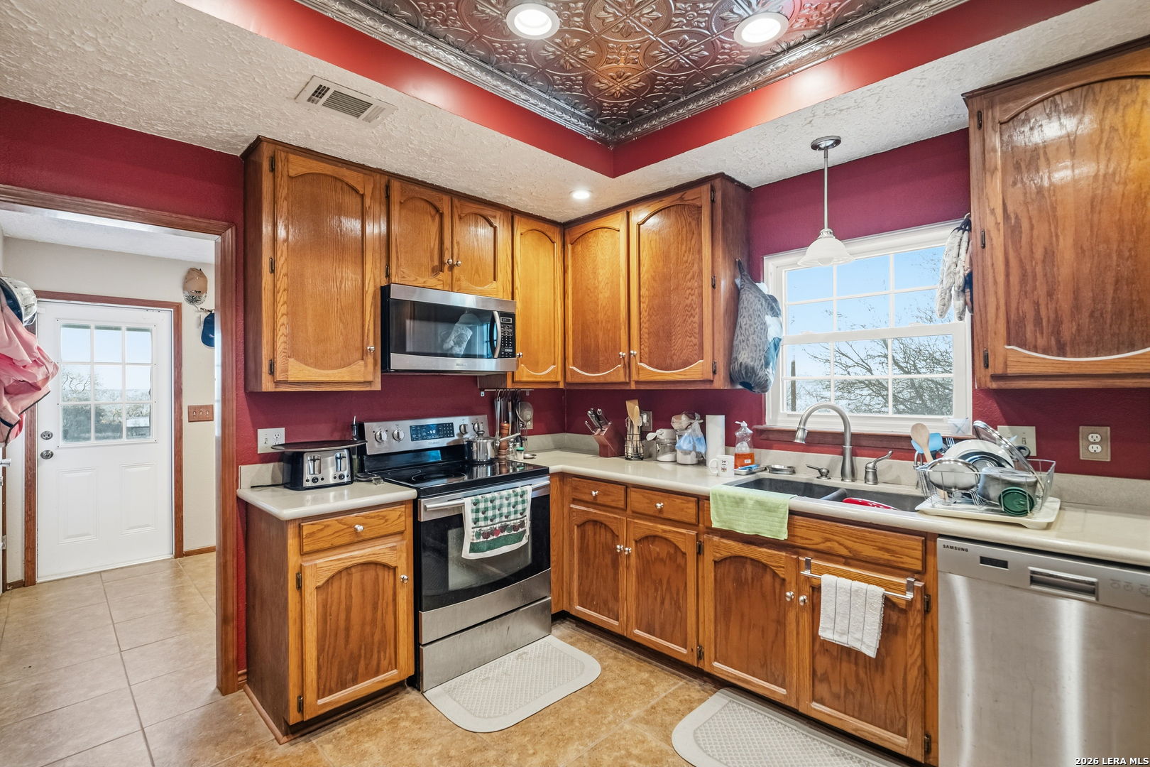 3940 Highway 90 Hondo, TX 78861 - Photo 12 of 24 a kitchen with stainless steel appliances granite countertop a stove a sink dishwasher and cabinets with wooden floor