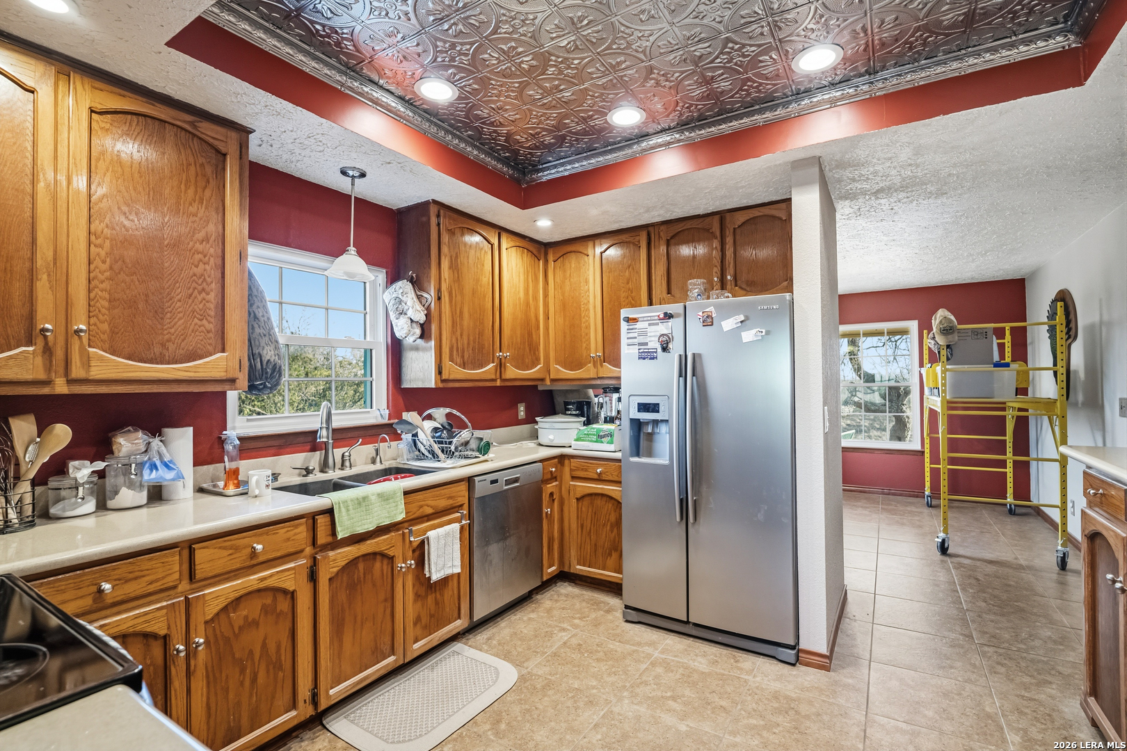 3940 Highway 90 Hondo, TX 78861 - Photo 13 of 24 a kitchen with stainless steel appliances granite countertop a refrigerator a oven a sink with wooden cabinets and floor