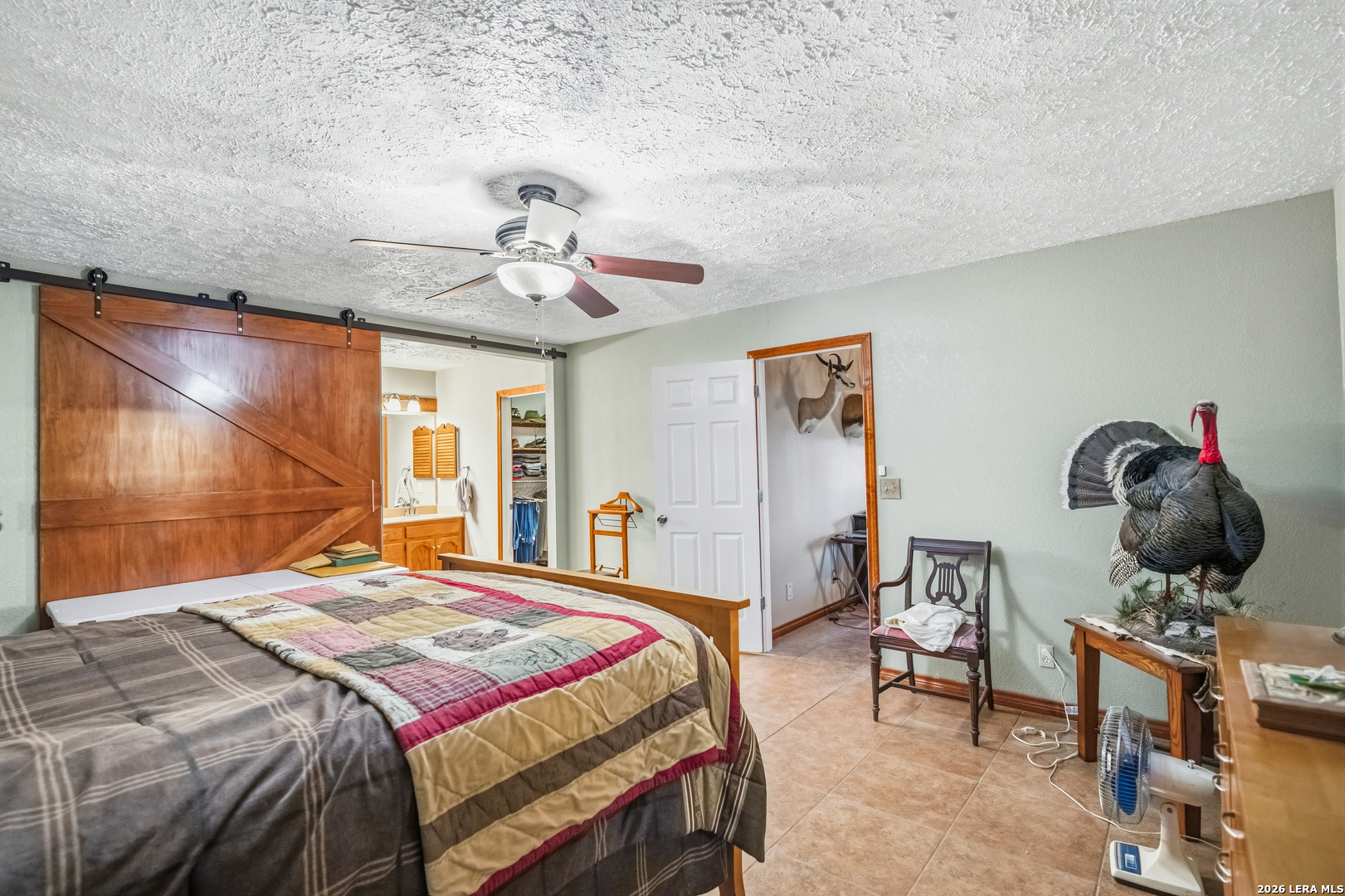 3940 Highway 90 Hondo, TX 78861 - Photo 17 of 24 a bedroom with a bed and a chandelier