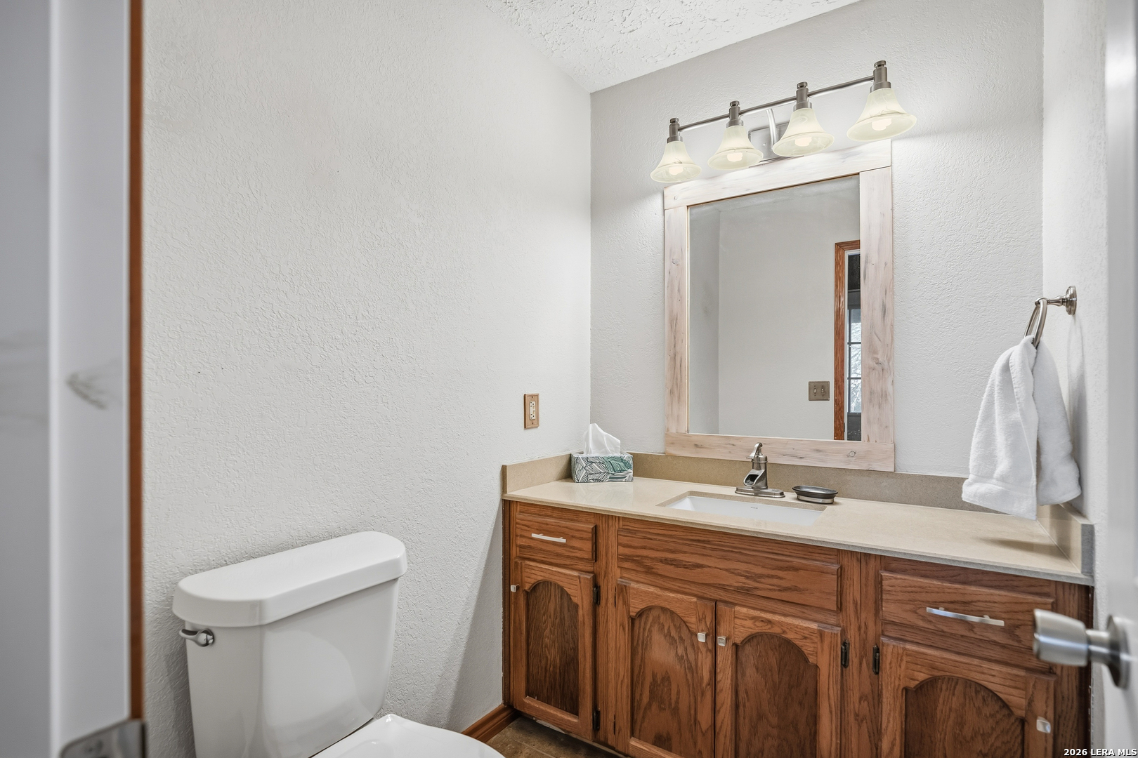 3940 Highway 90 Hondo, TX 78861 - Photo 22 of 24 a bathroom with a sink vanity granite and toilet