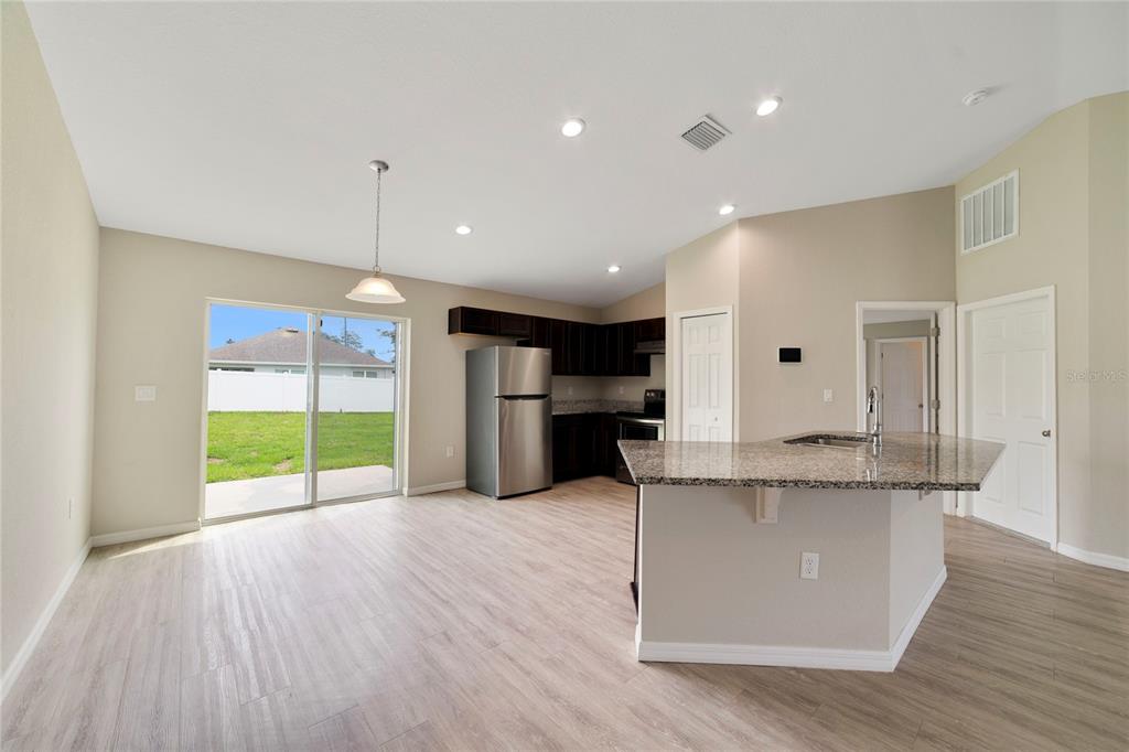 16271 Southwest 27th Terrace Road Ocala, FL 34473 - Photo 5 of 21 a large kitchen with stainless steel appliances granite countertop a large counter top a sink and a refrigerator