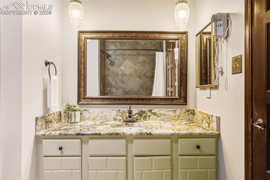 2771 Rigel Drive Colorado Springs, CO 80906 - Photo 24 of 50 Bathroom #2, Granite countertop, framed mirror, and updated lighting create a polished and cohesive look.