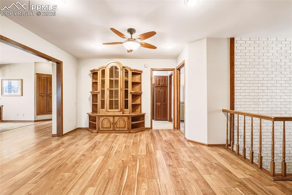 2771 Rigel Drive Colorado Springs, CO 80906 - Photo 3 of 50 Open landing with updated flooring and natural light provides flexible space for reading, display, or additional seating.