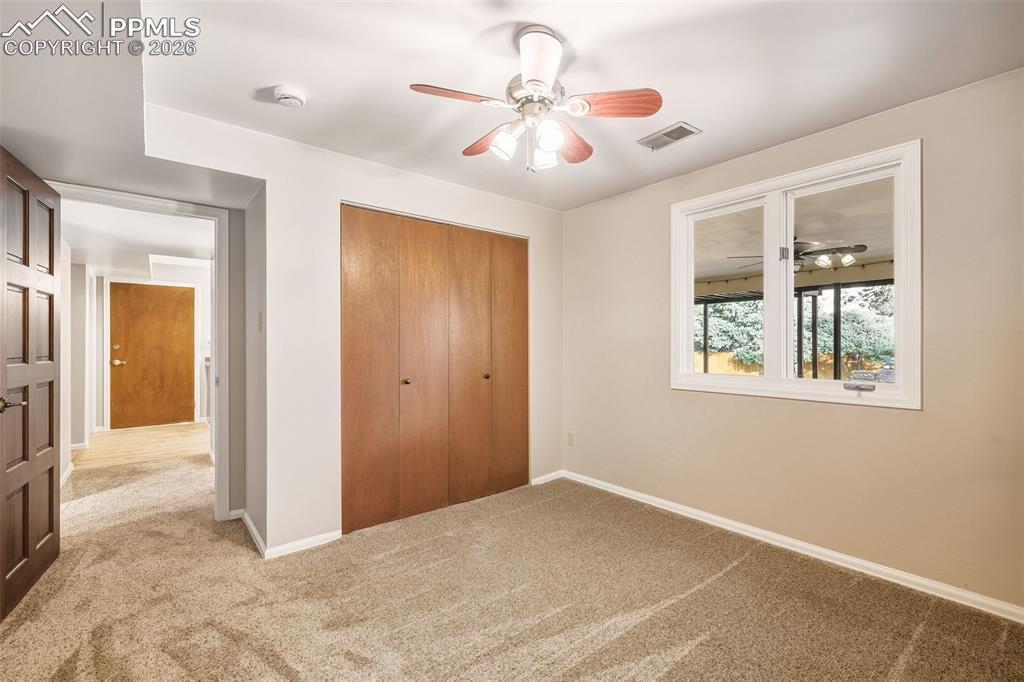 2771 Rigel Drive Colorado Springs, CO 80906 - Photo 34 of 50 Flexible bedroom #4 with nice carpet & Ceiling fan with above grade window.