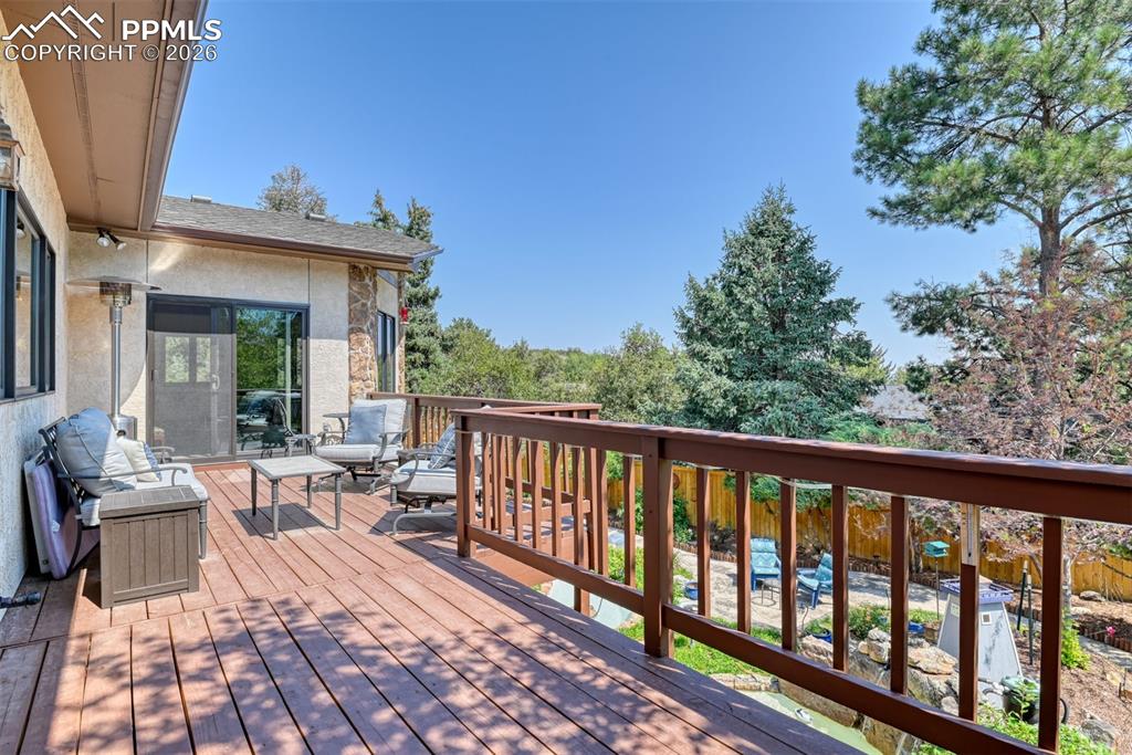 2771 Rigel Drive Colorado Springs, CO 80906 - Photo 44 of 50 Private outdoor retreat with ample room for seating, treetop views, and seamless access from the main living area through updated sliding glass doors.