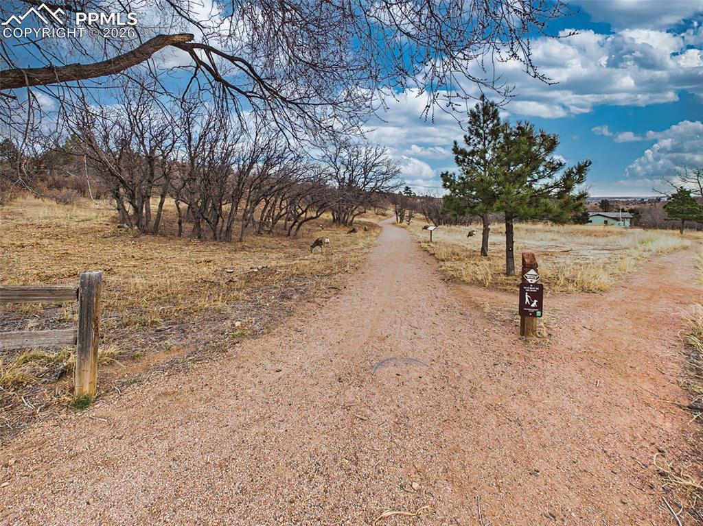 2771 Rigel Drive Colorado Springs, CO 80906 - Photo 49 of 50 Bear Creek Regional Park is known for its extensive network of walking, hiking, and biking trails that wind through scenic natural landscapes and along the creek. One of the trail access points is conveniently located directly across the street from the property, offering easy entry to miles of multi-use paths ideal for casual strolls, trail running, and mountain biking. The connected trail system weaves through open meadows, wooded areas, and peaceful natural surroundings, creating a seamless way to stay a