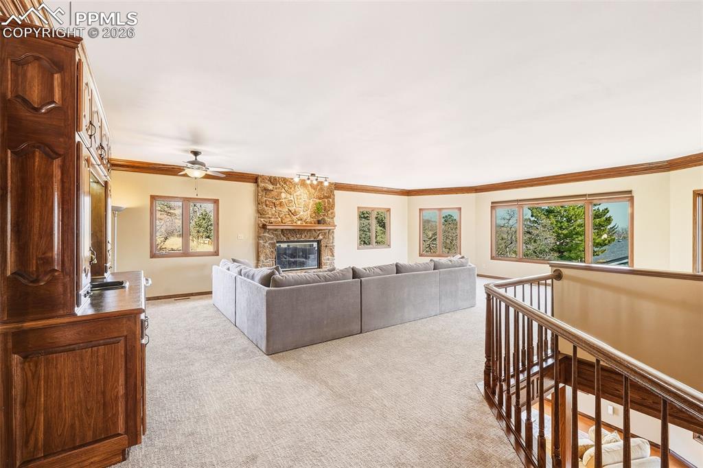 2771 Rigel Drive Colorado Springs, CO 80906 - Photo 6 of 50 Elevated position with railing detail and expansive windows offers peaceful, tree-framed views and a bright, airy feel.