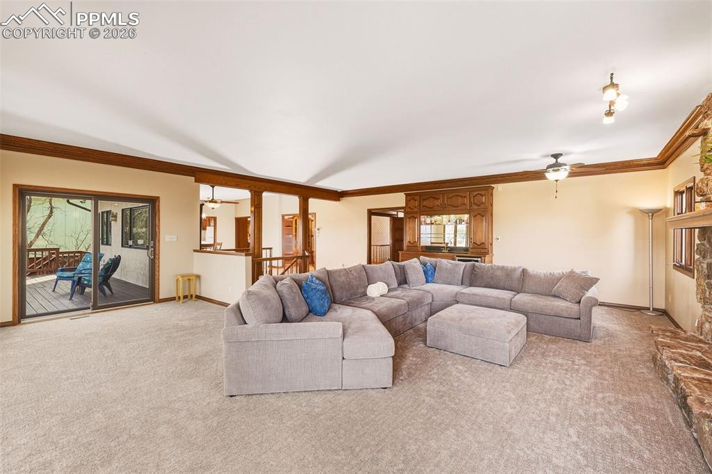 2771 Rigel Drive Colorado Springs, CO 80906 - Photo 10 of 50 Open-concept design connects the living room to the dining area and upper deck, creating an ideal setting for entertaining or everyday living. Sliding glass doors enhance indoor-outdoor flow.