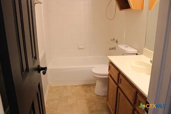 a bathroom with a sink a toilet and shower curtain