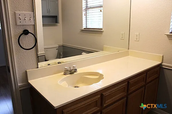 a bathroom with a sink vanity and a mirror