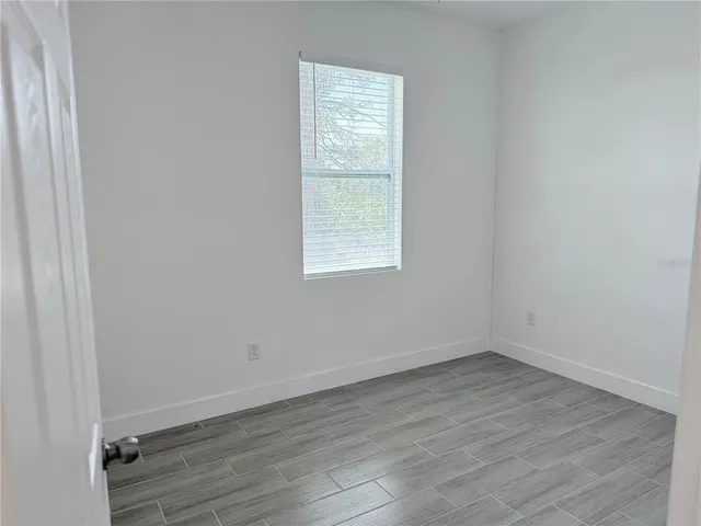 wooden floor and window in an empty room