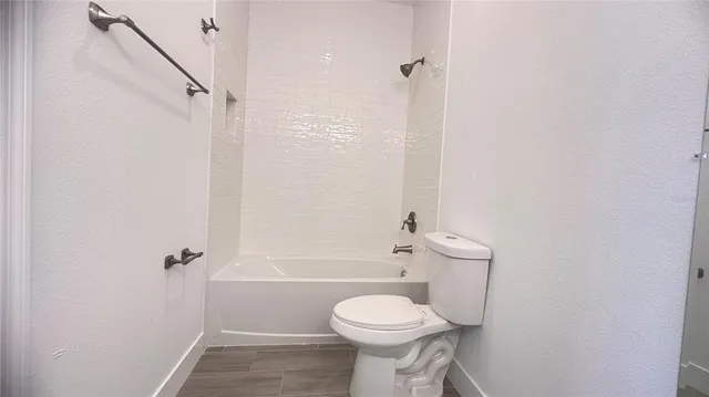 a bathroom with a toilet sink and shower