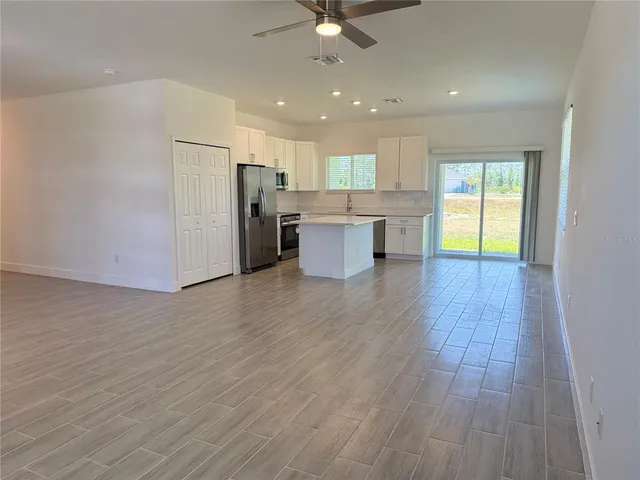 a view of a kitchen with a sink and a refrigerator