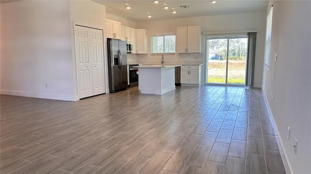 a view of kitchen with cabinets and stainless steel appliances