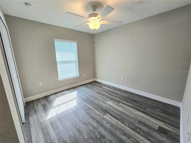 a bathroom with a granite countertop sink a toilet and bathtub
