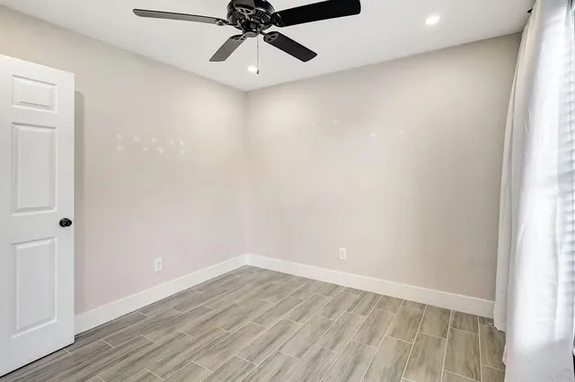 a view of a room with wooden floor closet and windows